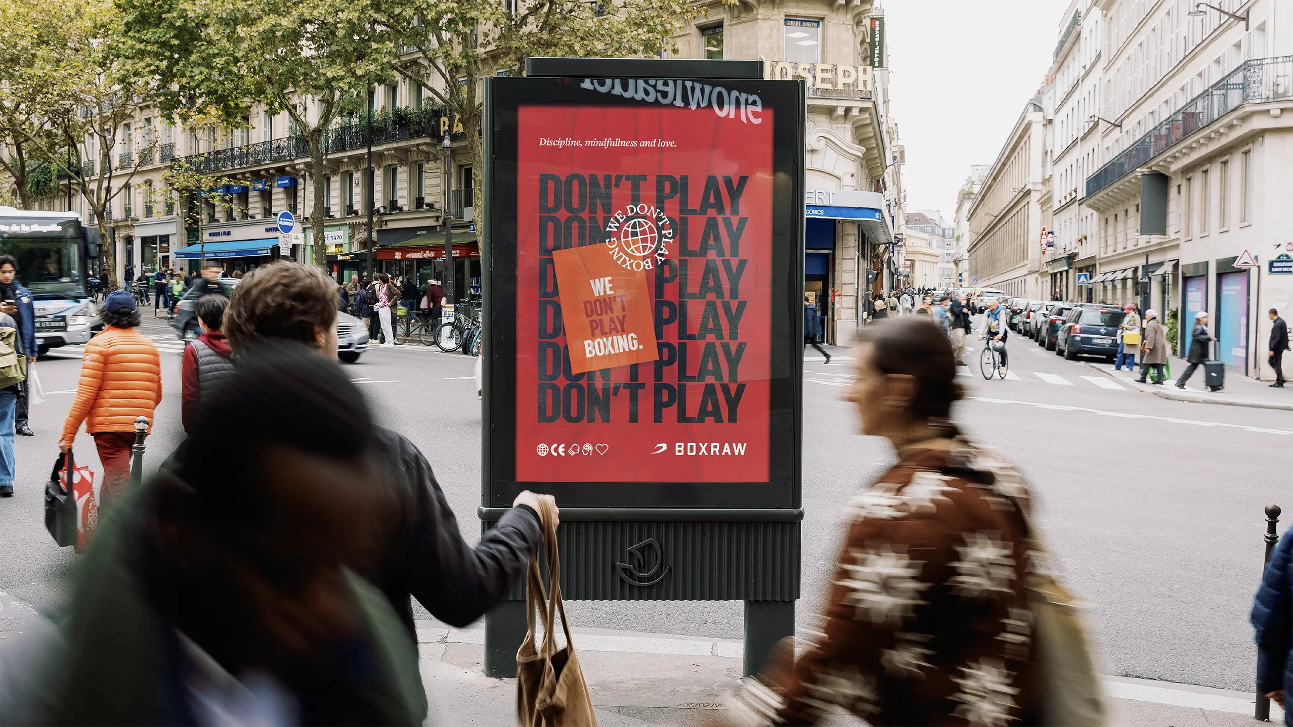 &lsquo;Don&rsquo;t Play&rsquo; poster in a street advertising column on a busy boulevard.