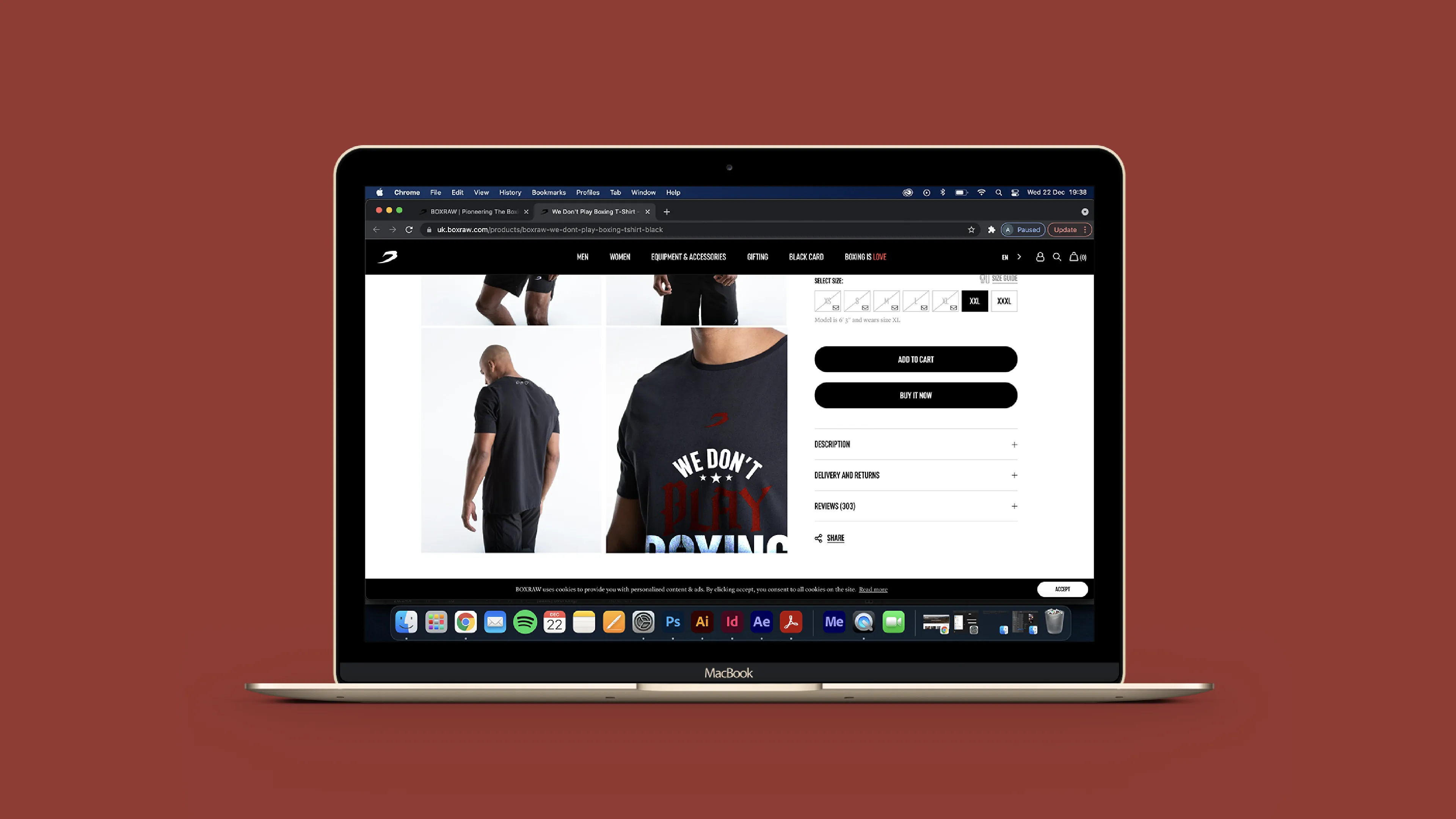 The BOXRAW &lsquo;We Don&rsquo;t Play Boxing&rsquo; T-shirt product page open on a MacBook against a brick-red backdrop.